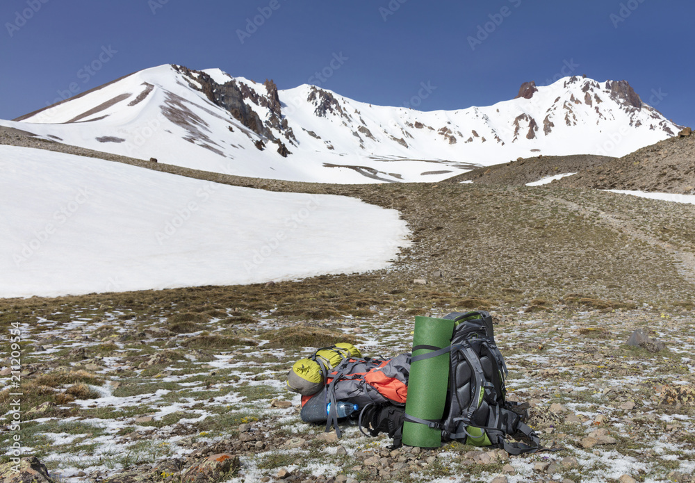 Backpacks of tourists are located at the foot of Mount Backpacks of tourists are located at the foot of Mount