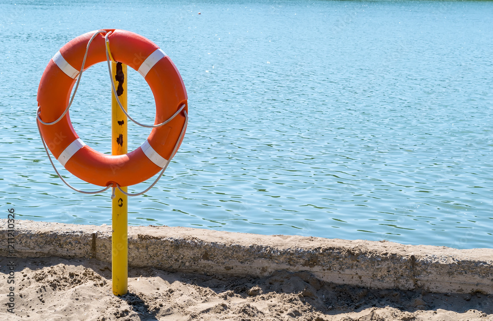 a life preserver on the shore of the lake to rescue drowning