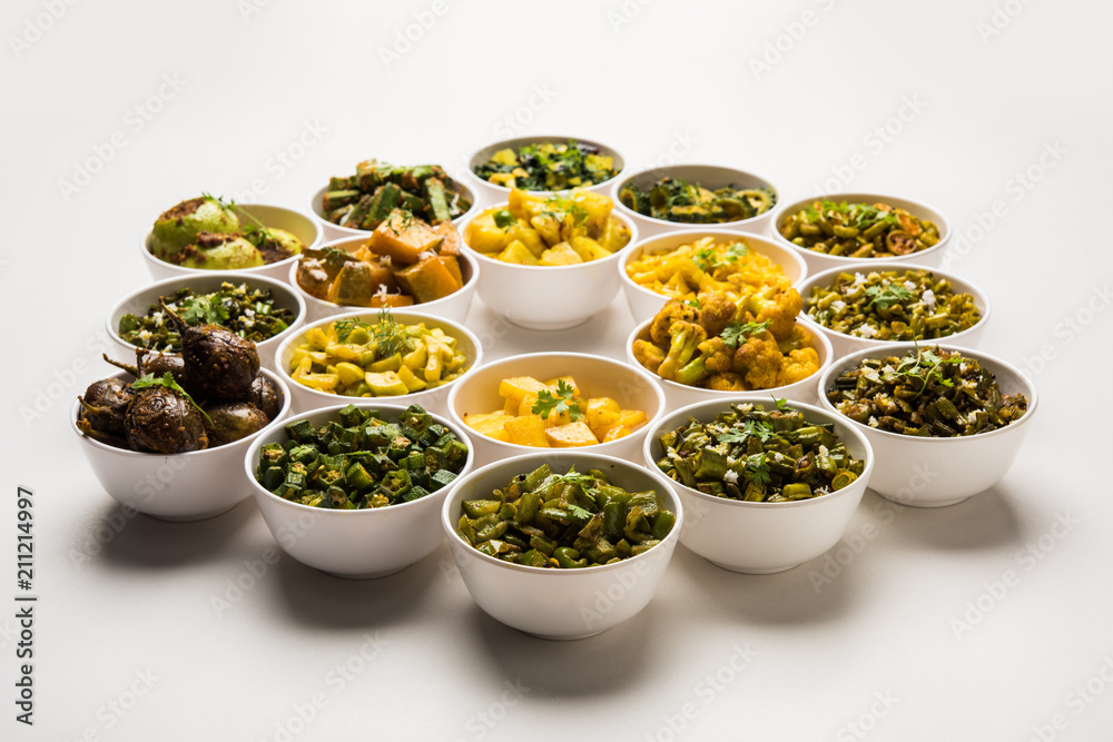 Indian sabzi / vegetable fried recipes served in white bowl over moody or colourful background. selective focus