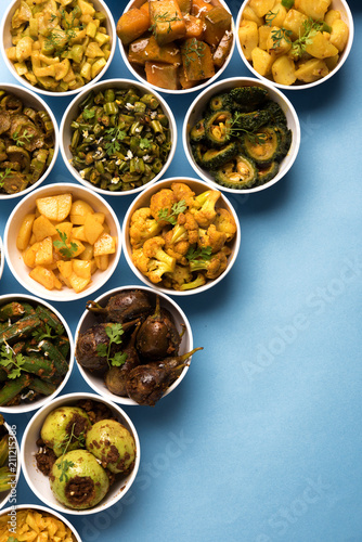 Indian sabzi / vegetable fried recipes served in white bowl over moody or colourful background. selective focus photo