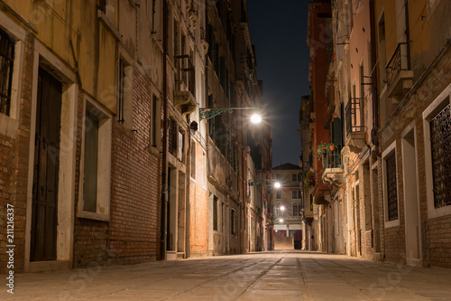Night view of a small street in Venice, Italy. Architecture and sights of Venice. Nightlife in Venice. Venetian postcard with a night view