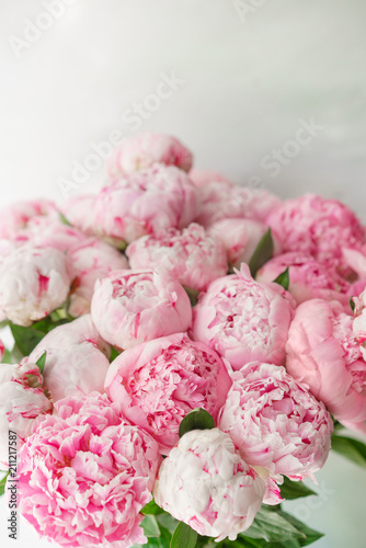 Fototapeta Naklejka Na Ścianę i Meble -  Beautiful bouquet of pink peonies . Floral composition, daylight. Wallpaper. Lovely flowers in glass vase.