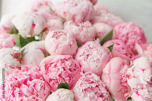 Fototapeta Naklejka Na Ścianę i Meble -  Beautiful bouquet of pink peonies . Floral composition, daylight. Wallpaper. Lovely flowers in glass vase.