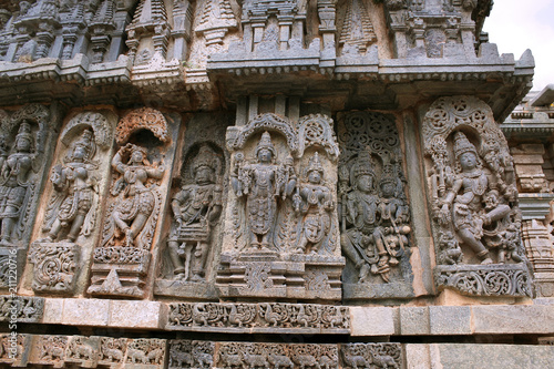 Ornate bas relieif and sculptures of Hindu deities, Kedareshwara Temple, Halebid, Karnataka photo