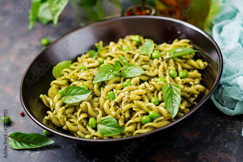 Fusilli pasta with  pesto sauce  green peas and basil. Italian food.