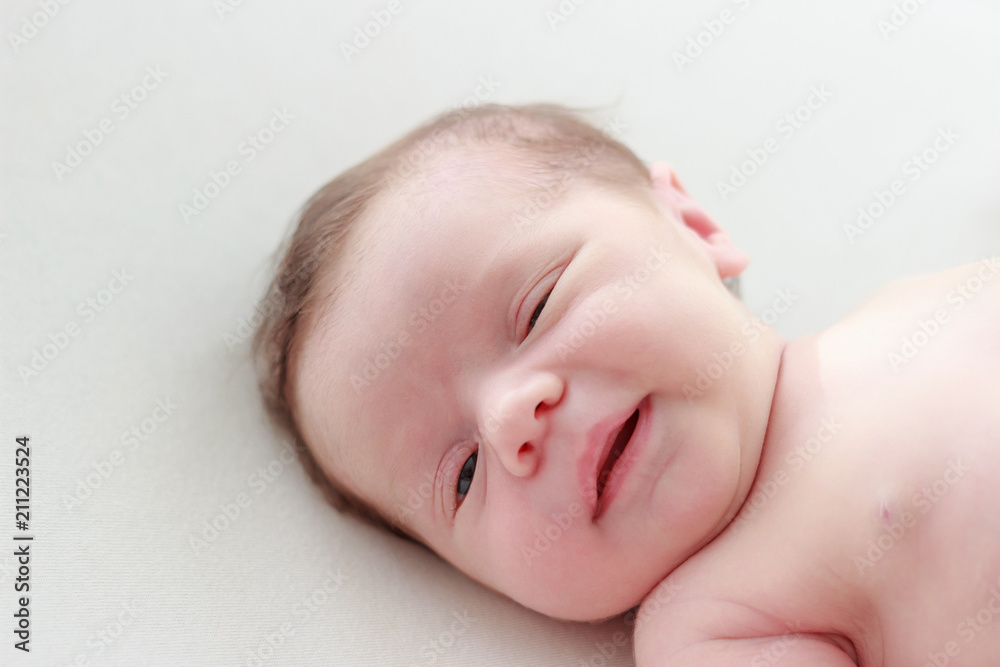 Portrait of a newborn baby laying on a blanket Portrait of a newborn baby laying on a blanket
