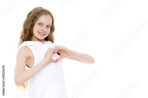 Little girl shows heart with her hands.