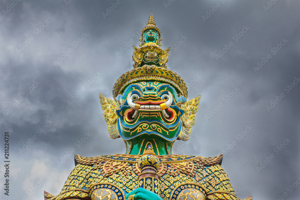 Demon Guardian with cloudy sky at Wat Phra Kaew , The Temple of Emerald Buddha in Bangkok, Thailand