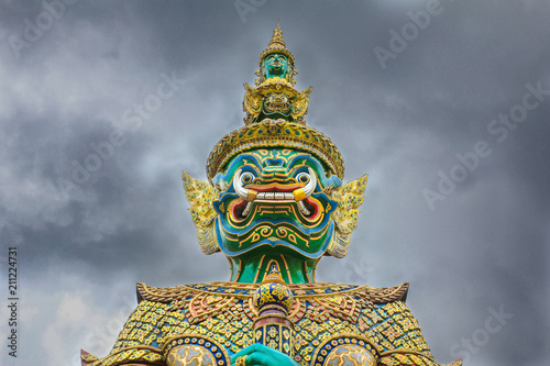 Demon Guardian with cloudy sky at Wat Phra Kaew , The Temple of Emerald Buddha in Bangkok, Thailand