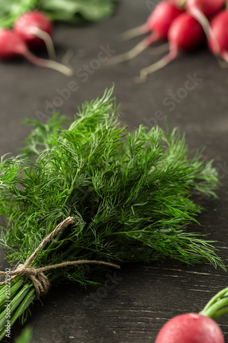 Bunch of fresh dill with radish on wooden table
