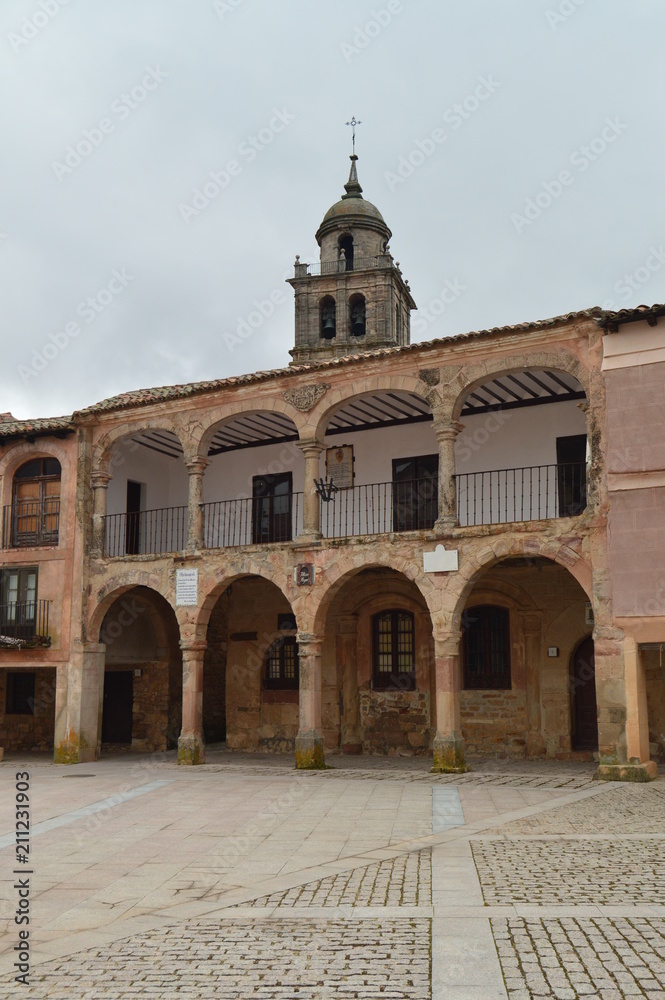 Fototapeta premium Main Square With Arched Portals In The High Part View Of The Church Tower In The Village Of Medinaceli. Architecture, History, Travel. March 19, 2016. Medinaceli, Soria, Castilla Leon, Spain.