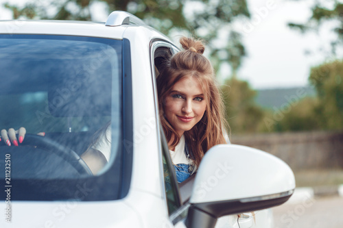 Trendy girl traveling by car
