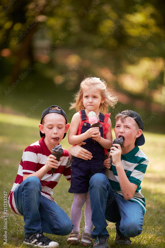 Fototapeta premium The small children eating ice creams