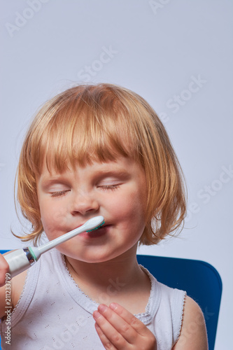 baby brushing her teeth