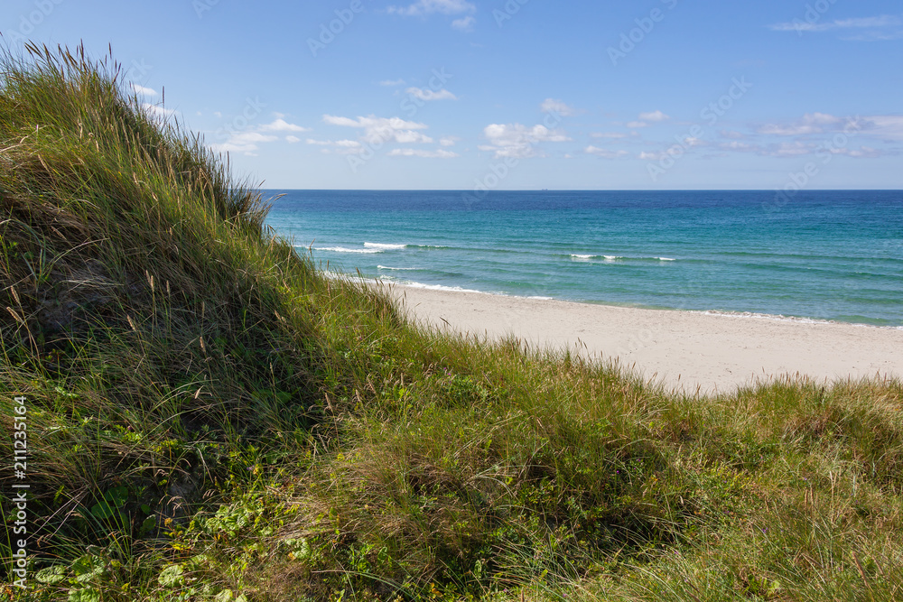 Sandy dunes covered with a grass on lovely Sola Strand beach near Stavanger, Norway Sandy dunes covered with a grass on lovely Sola Strand beach near Stavanger, Norway