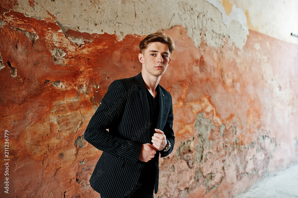 Young stylish macho boy in black jacket posed outdoor of street. Amazing model man. Young stylish macho boy in black jacket posed outdoor of street. Amazing model man.