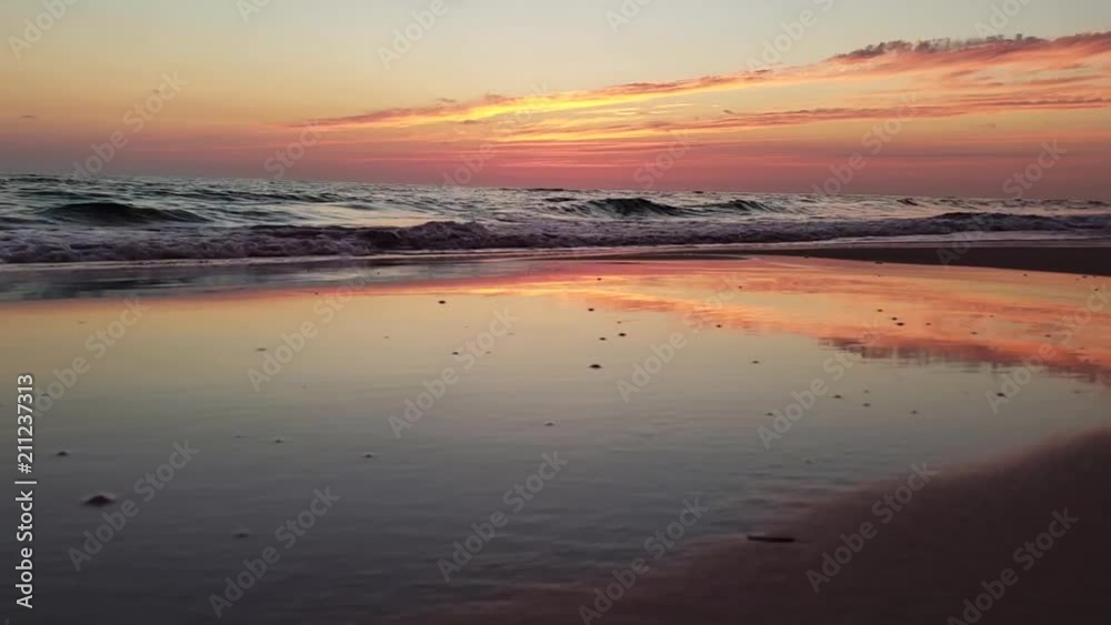 Hyperlapse of waves, sand, and sunset on the beach Hyperlapse of waves, sand, and sunset on the beach