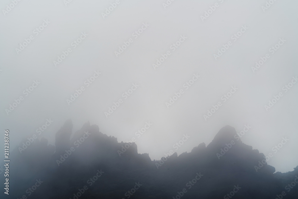 Peaks of the mountain in mist and clouds Peaks of the mountain in mist and clouds