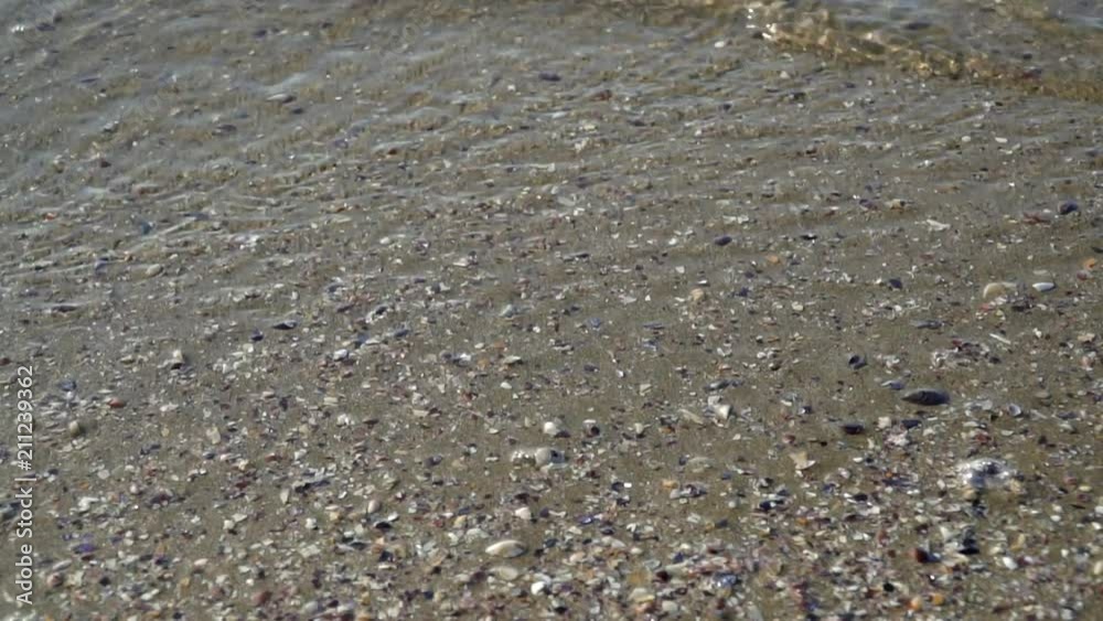 Small waves that hit the sand at the seaside. Caspian Sea. Slow motion. Small waves that hit the sand at the seaside. Caspian Sea. Slow motion.