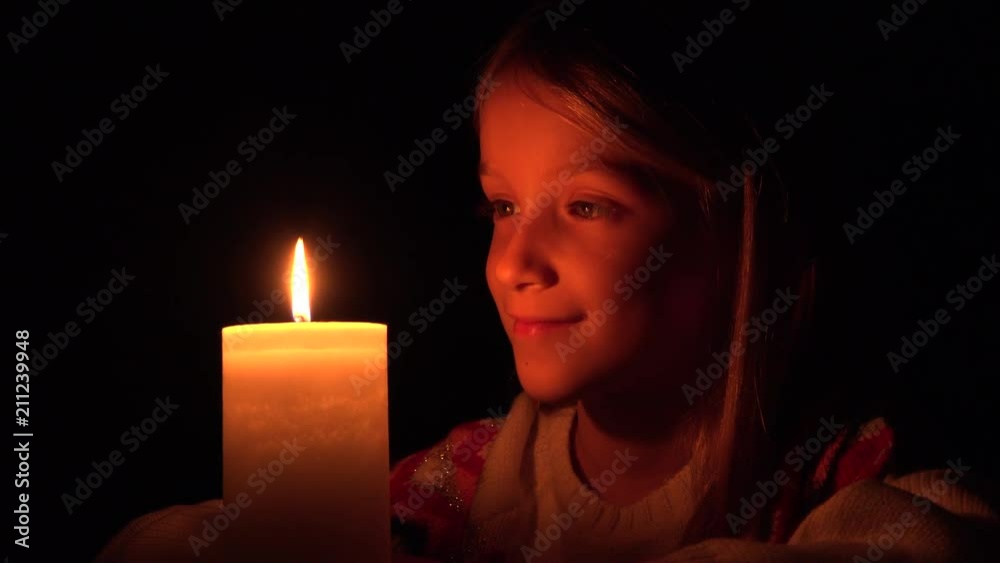Happy Child with Candles, Prayer Kid in Night, Girl Portrait, Face in Dark Happy Child with Candles, Prayer Kid in Night, Girl Portrait, Face in Dark