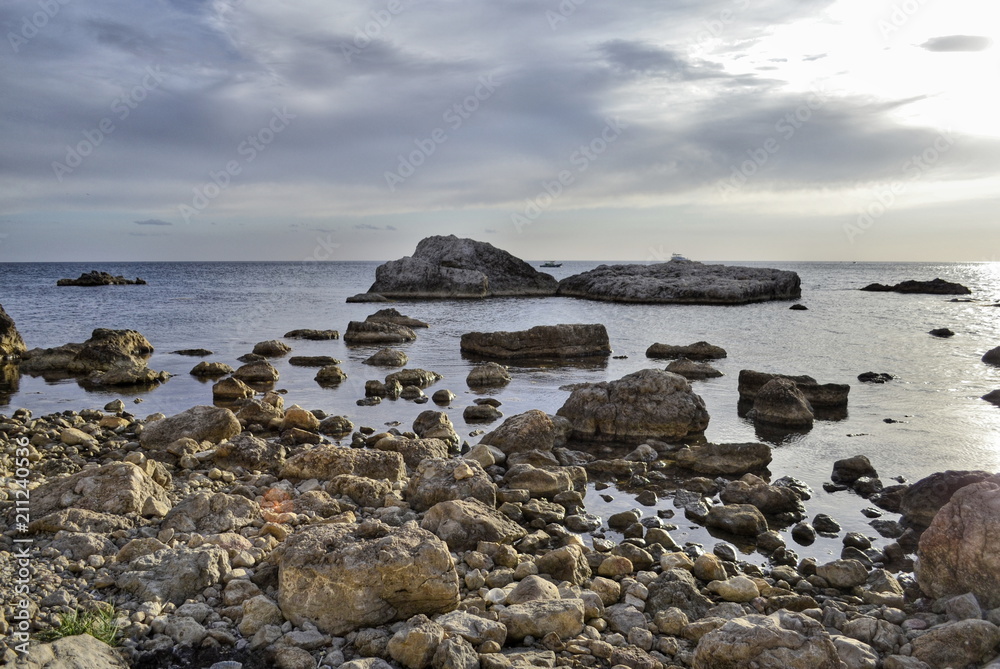Seascape, stones and boulders before sunset