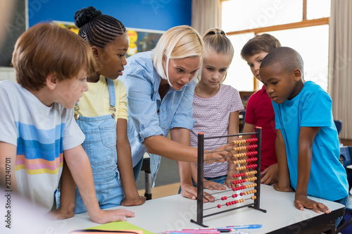 Teacher showing abacus to children photo