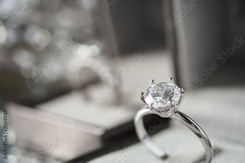 luxury engagement Diamond ring in jewelry gift box with bokeh light background photo