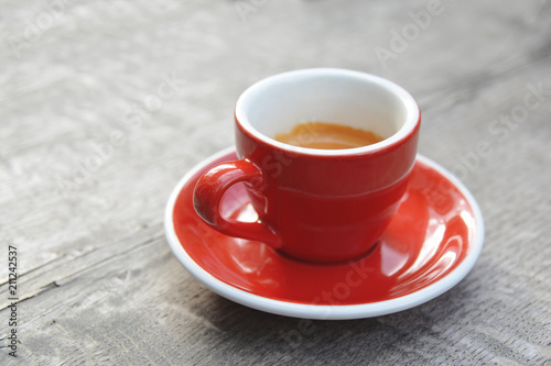 Red espresso morning first coffee on wooden cafeteria table