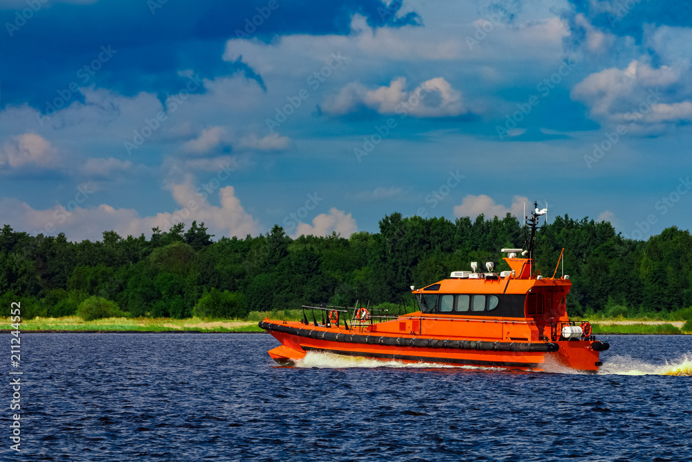 Orange pilot boat in action