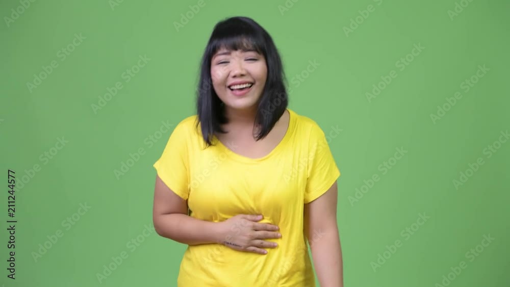 Beautiful happy Asian woman laughing Beautiful happy Asian woman laughing
