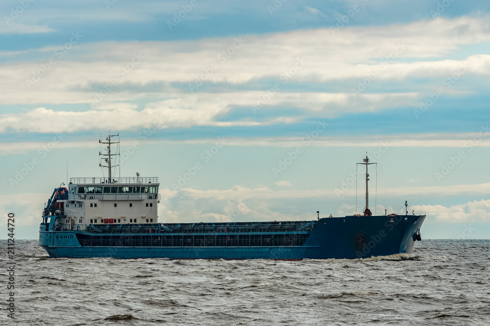 Blue cargo ship underway