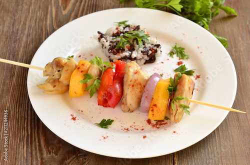 Skewers of chicken with vegetables and rice