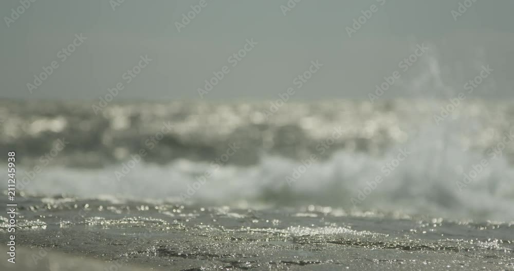 Waves breaking on shore