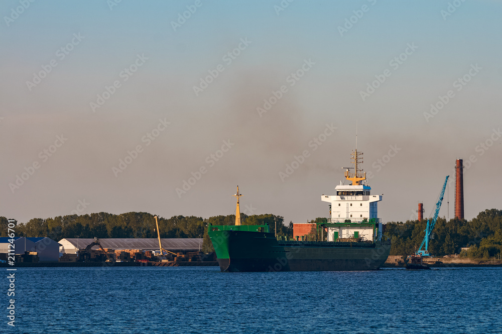 Green cargo ship in port