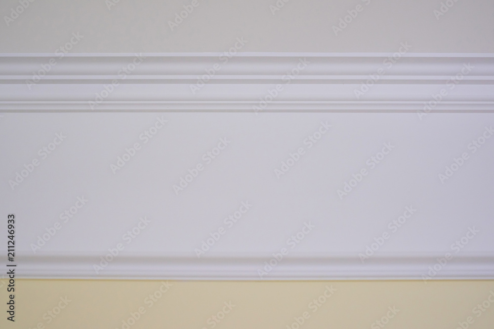 Detail of a flat ceiling skirting, ceiling moldings in the interior.  Details of the wall Stock Photo | Adobe Stock