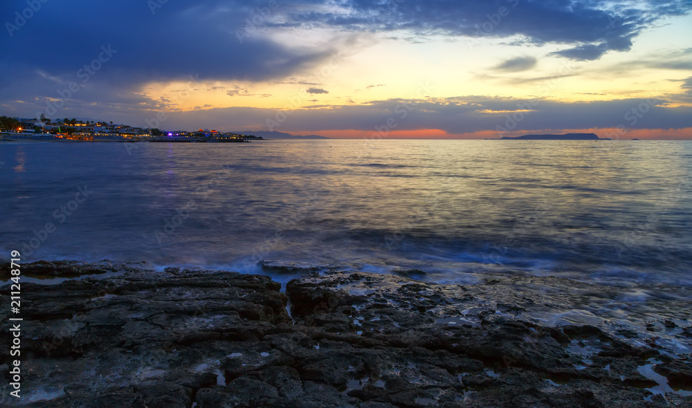 Fototapeta premium Nature in twilight period which including of sunrise over the sea and the nice beach. Summer beach with blue water and purple sky at the sunset.