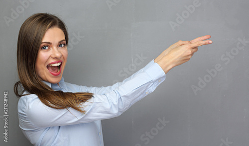 Smiling positive emotional business woman pointing finger to cop