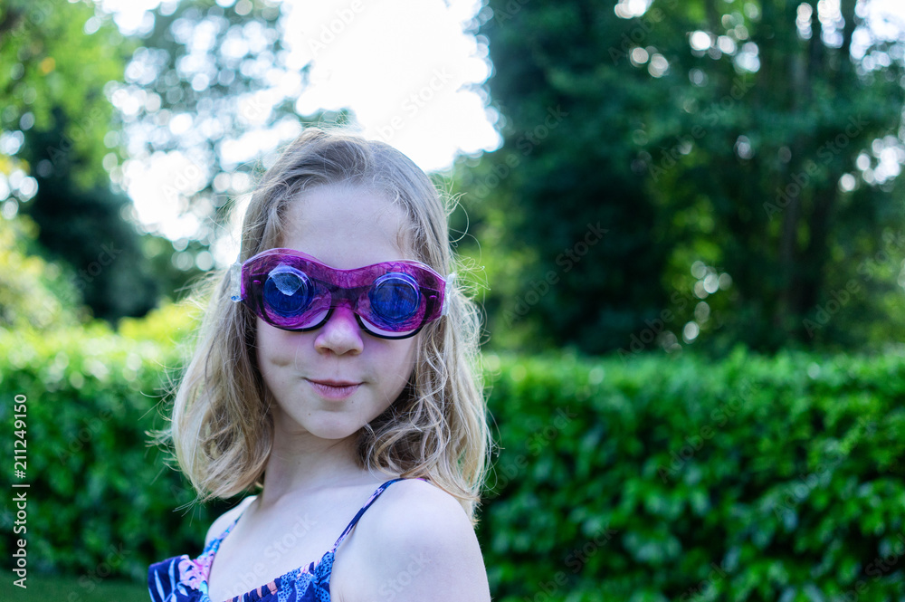 Portrait of a female child with some home made glasses over her real glasses Portrait of a female child with some home made glasses over her real glasses