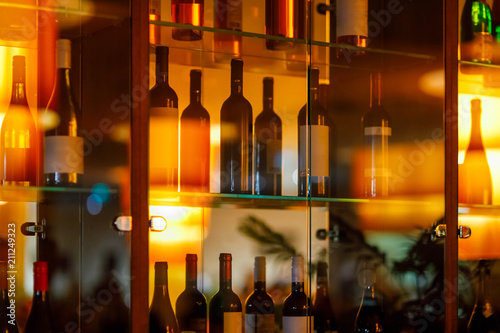 wine cabinet with glass shelves and door and reflection