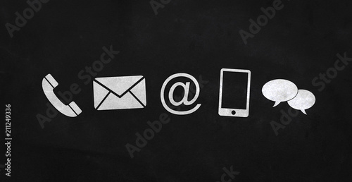 White contact icons on a blackboard