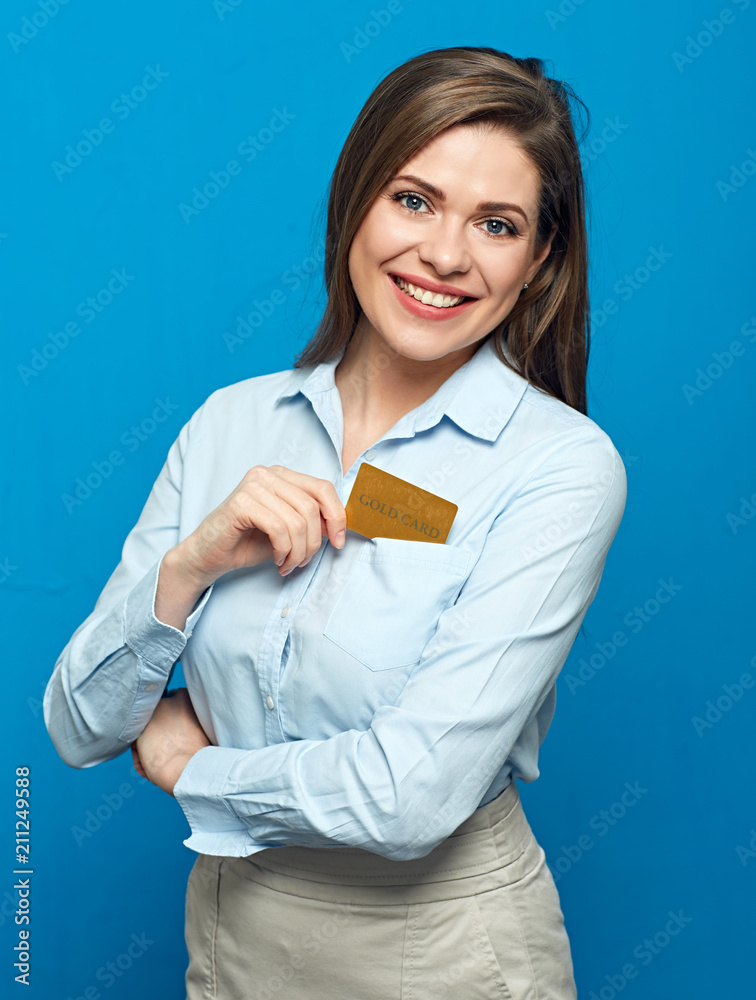 Happy woman holding gold credit card. Studio portrait isolated on blue wall back. Happy woman holding gold credit card. Studio portrait isolated on blue wall back.