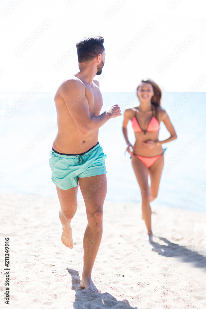 Happy couple having fun on the beach. Happy couple having fun on the beach.