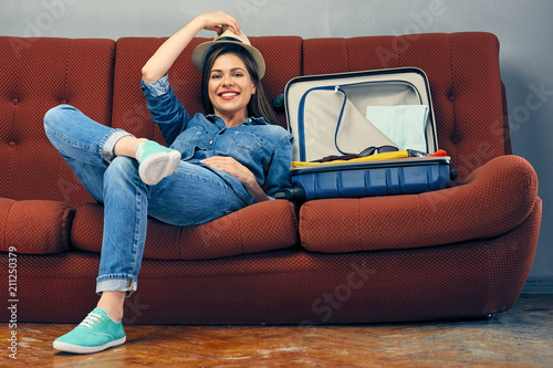 Woman traveler prepare suitcase for summer vacation.