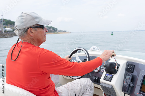 Man driving a motor cruiser on the sea