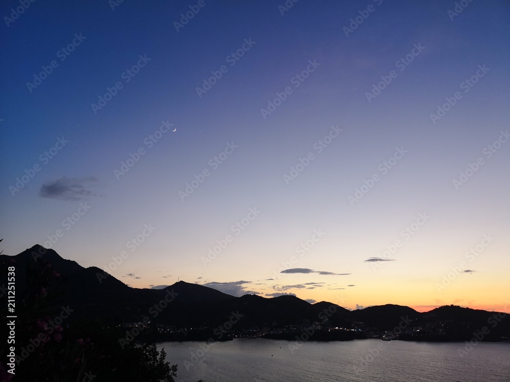 Sunset above island mountains