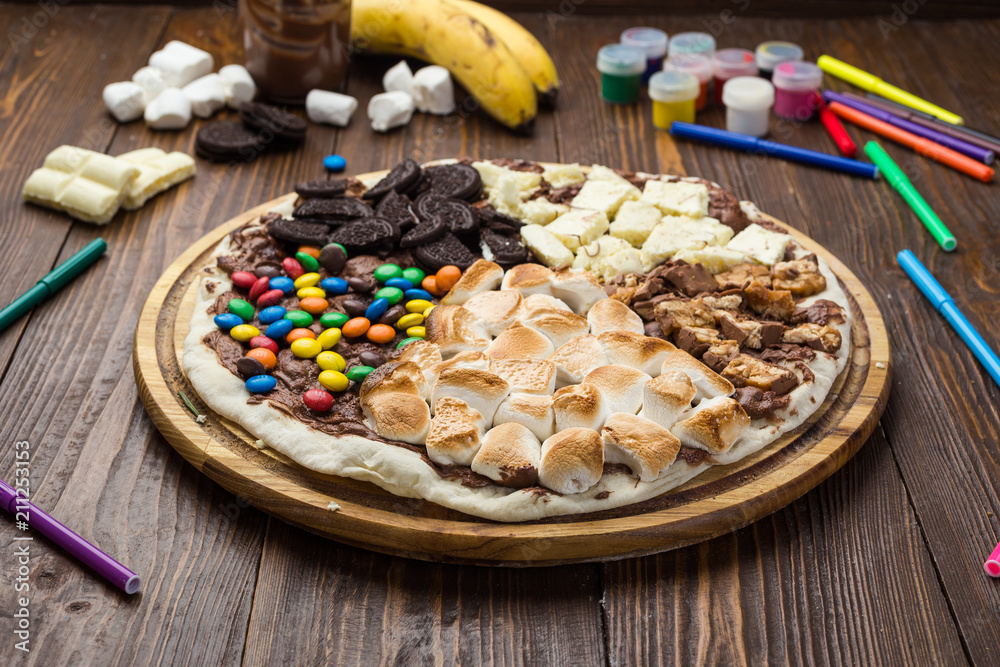 sweet pizza with chocolate and marshmallow on wooden background sweet pizza with chocolate and marshmallow on wooden background