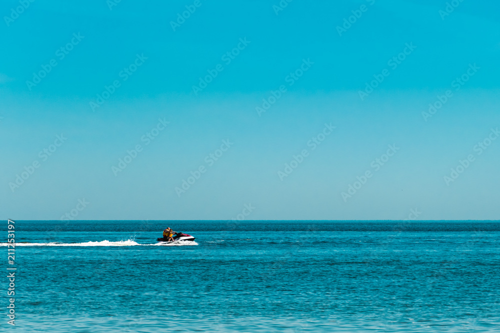 two people on a jet ski floating on the sea