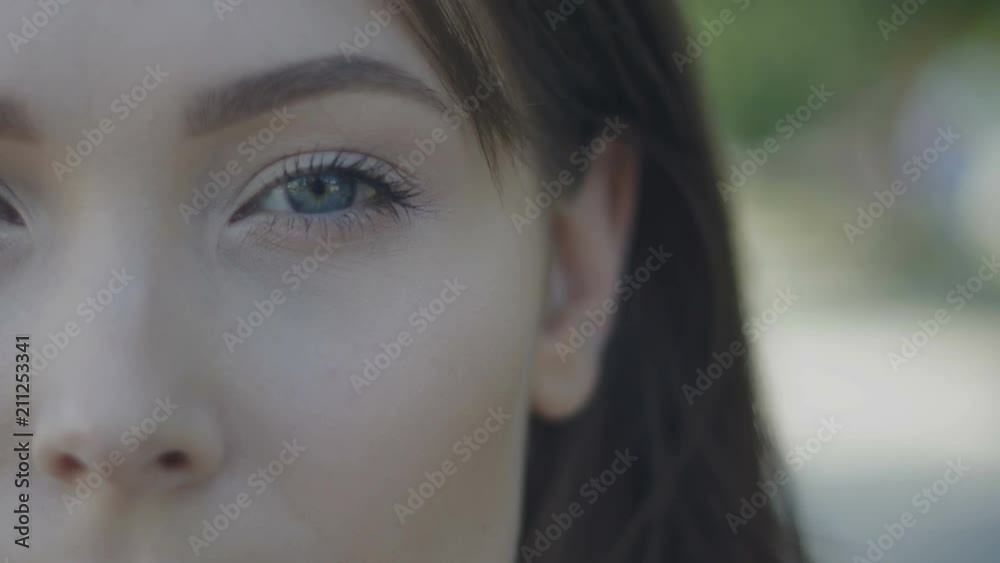Close-up shot of young woman's blue eye with light day make-up outdoor Close-up shot of young woman's blue eye with light day make-up outdoor