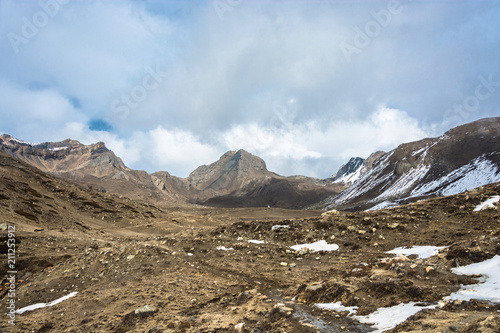 Mountain landscape with snow on the trail and white clouds, Nepal.