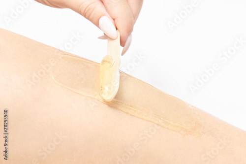 Sugar hair removal from woman body. Wax epilation spa procedure. Procedure beautician female. Leg